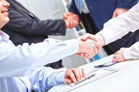 commercial plumbers shaking hands