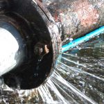 burst plumbing pipe in need of repair