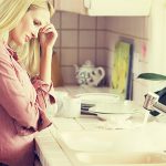 woman frustrated with clogged sink drain